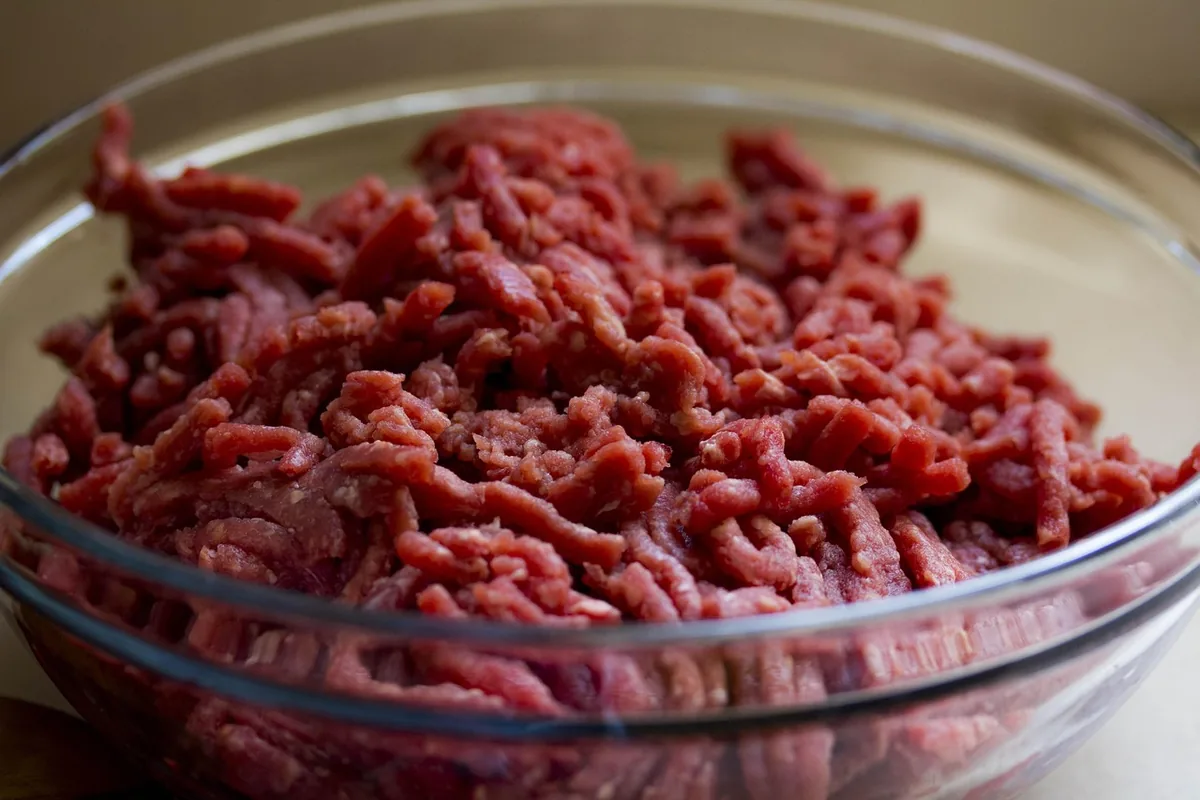 How long does ground beef last in the fridge: fresh raw ground beef like this in a glass bowl keeps 1 to 2 days