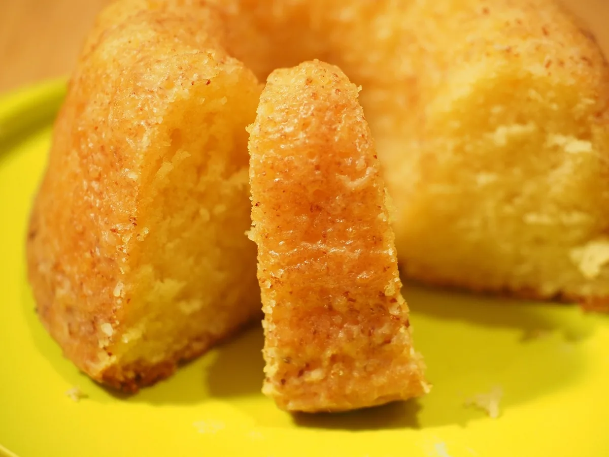 Slice cut from a golden pound cake showing its fine, dense crumb