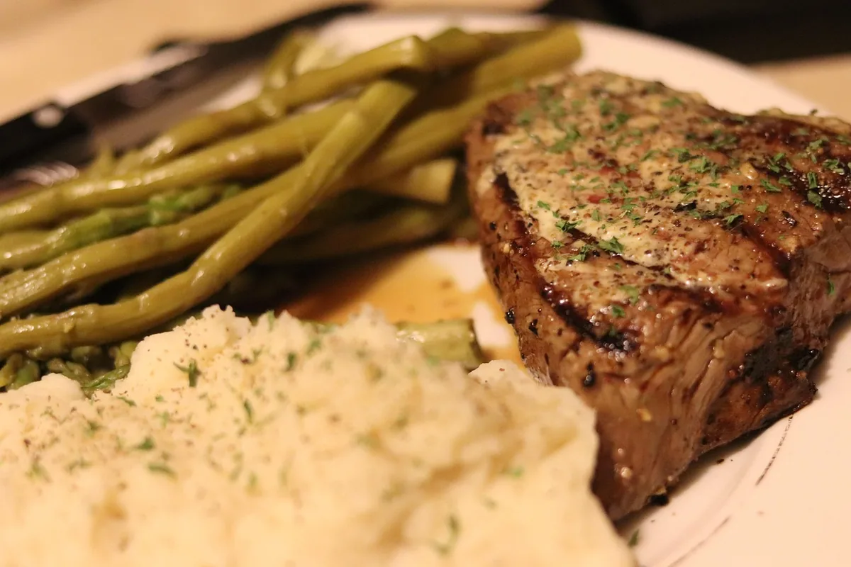Steak dinner plate with mashed potatoes and roasted asparagus