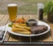 Seared steak with fries and a cup of sauce, served bistro style as in this steak au poivre recipe