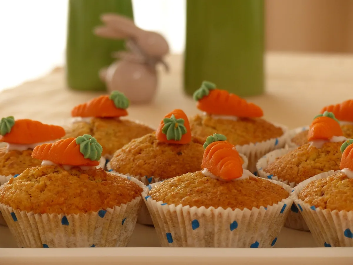 Carrot cupcakes topped with small orange decorative carrots