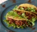 Ground beef tacos with lettuce on a blue plate, one of these healthy ground beef recipes