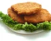 Air fryer chicken cutlets: three golden breaded chicken cutlets on a bed of curly lettuce