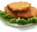 Air fryer chicken cutlets: three golden breaded chicken cutlets on a bed of curly lettuce