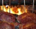 Picanha steak churrasco style: C-shaped beef on skewers grilling over an open wood fire