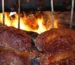 Picanha steak churrasco style: C-shaped beef on skewers grilling over an open wood fire