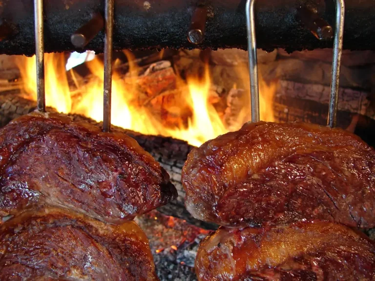 Picanha steak churrasco style: C-shaped beef on skewers grilling over an open wood fire