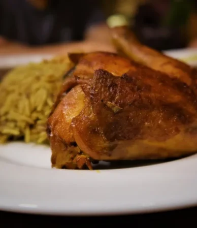 Golden oven baked chicken served on a plate with rice, similar to this oven baked chicken breast