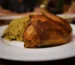 Golden oven baked chicken served on a plate with rice, similar to this oven baked chicken breast