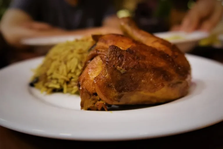 Golden oven baked chicken served on a plate with rice, similar to this oven baked chicken breast