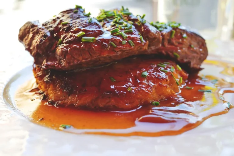Browned steak in a glossy brown gravy with chives, similar to this cube steak recipe