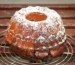 Bundt cake dusted with powdered sugar on a cooling rack, similar to this sweet potato pound cake recipe