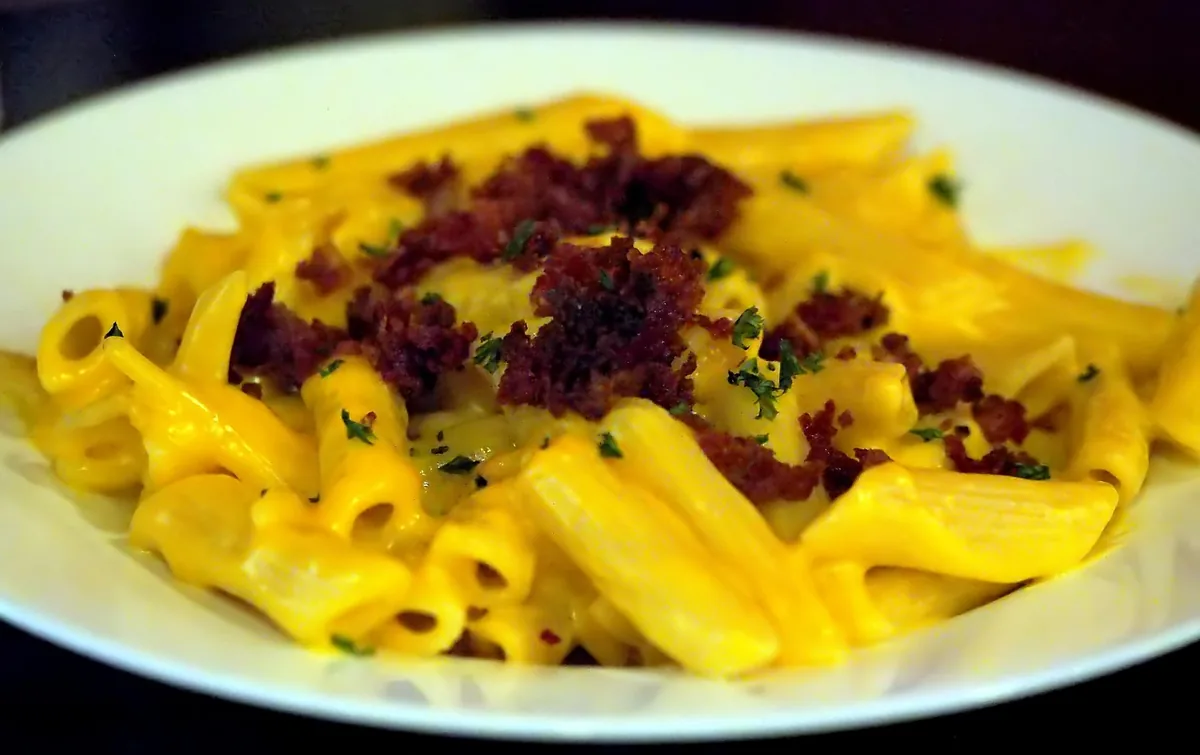 Creamy cheddar penne topped with crumbled bacon and herbs, similar to chicken bacon ranch pasta