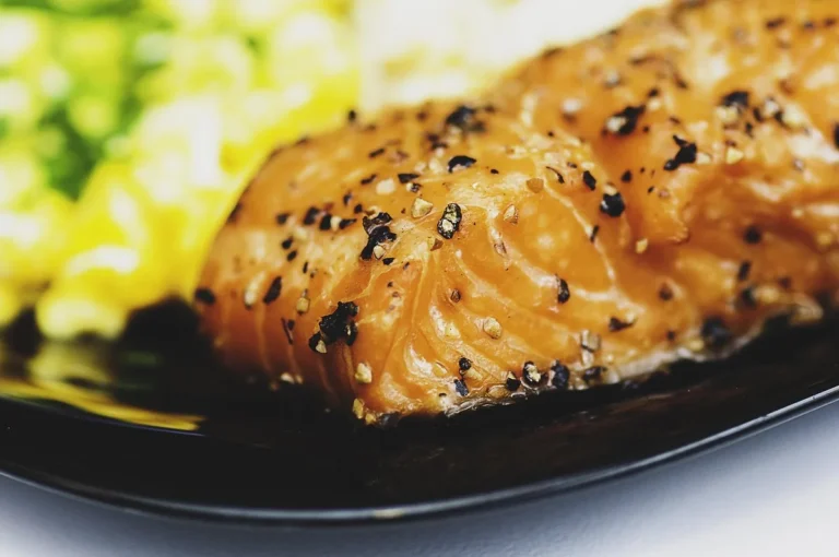 Peppered salmon fillet on a dark plate, similar to the result of how long to bake salmon at 350°F