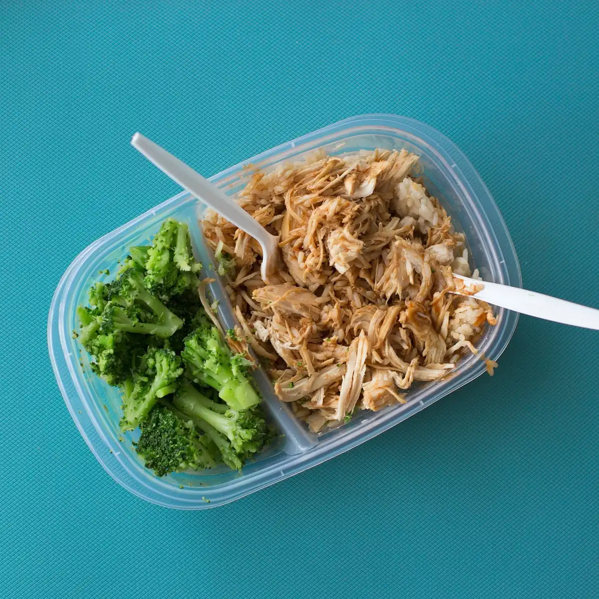 Shredded chicken with broccoli in a meal prep container
