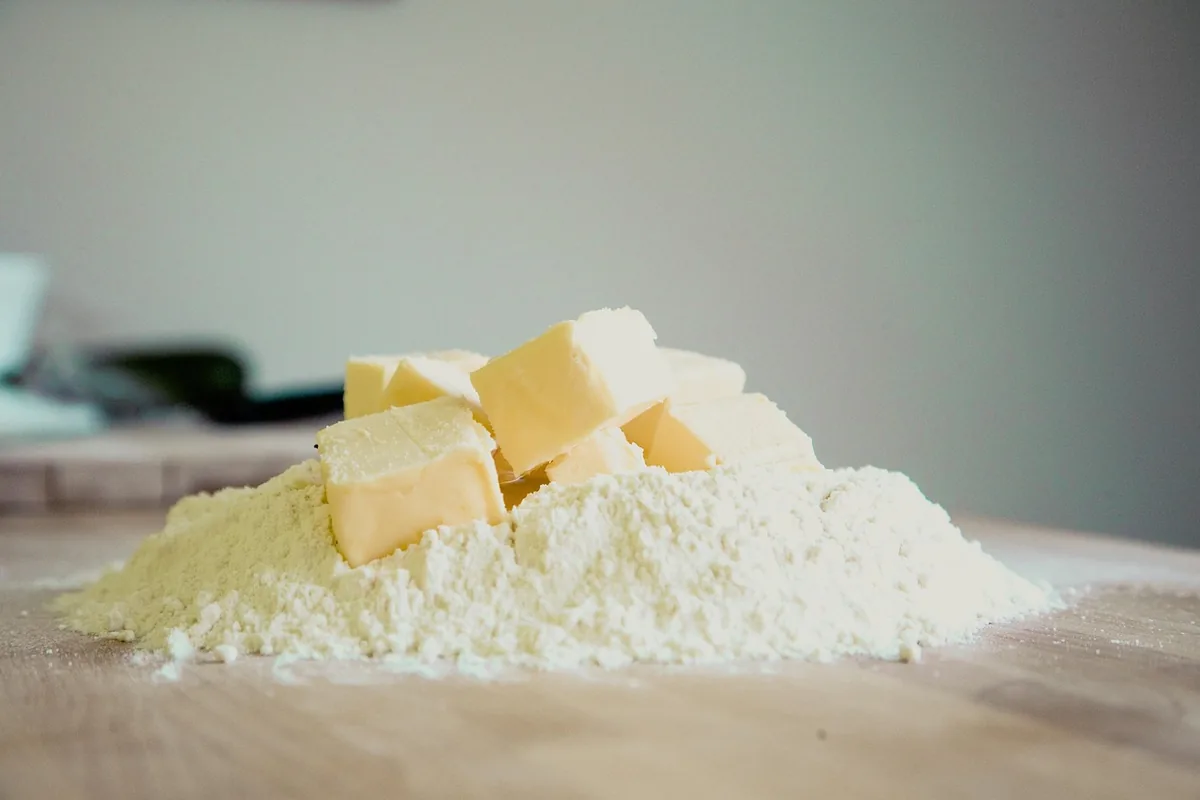 Cubes of butter on a pile of flour, the base of a homemade dump cake topping