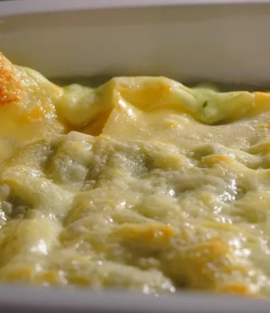 Golden cheese-topped casserole in a white baking dish, similar to this chicken broccoli rice casserole