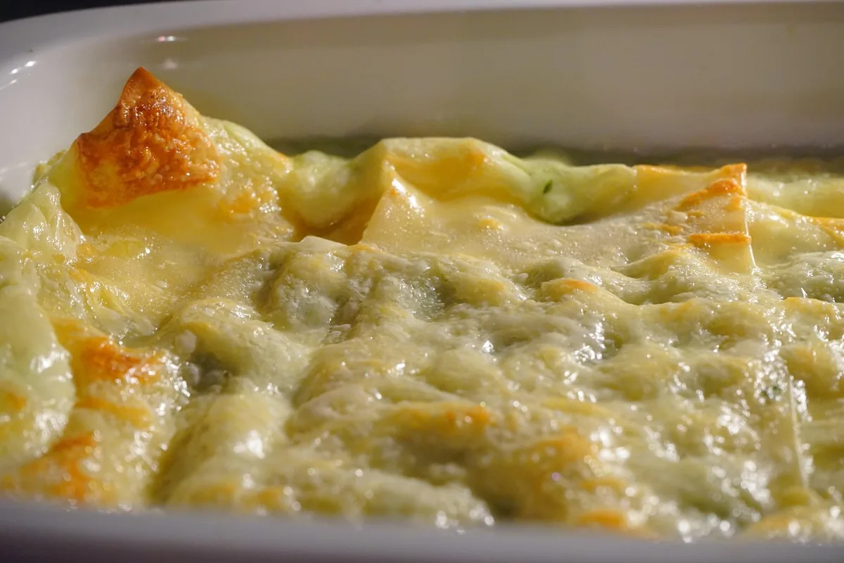 Golden cheese-topped casserole in a white baking dish, similar to this chicken broccoli rice casserole