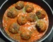 Meatballs simmering in tomato sauce in a skillet, similar to these homemade meatballs, showing how to make meatballs in sauce