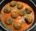 Meatballs simmering in tomato sauce in a skillet, similar to these homemade meatballs, showing how to make meatballs in sauce