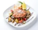 Glazed salmon fillet over roasted vegetables with a dark sauce drizzle, similar to this teriyaki salmon recipe
