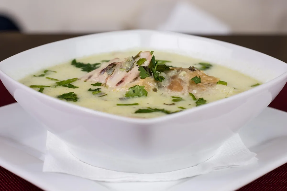 Creamy chicken soup with herbs in a white bowl, similar to this chicken gnocchi soup