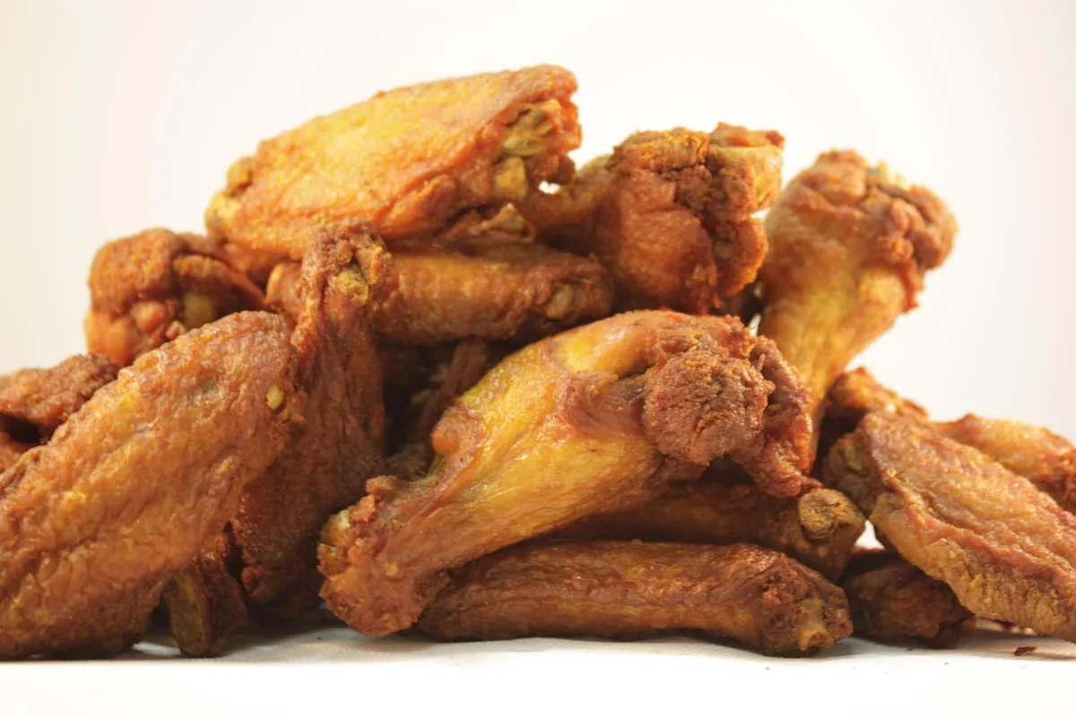 Golden double-fried chicken wings with a crisp crust before they are tossed in the glaze
