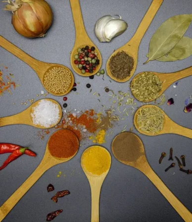 Wooden spoons of paprika, salt, pepper and dried herbs, similar to the spices in this homemade salmon seasoning