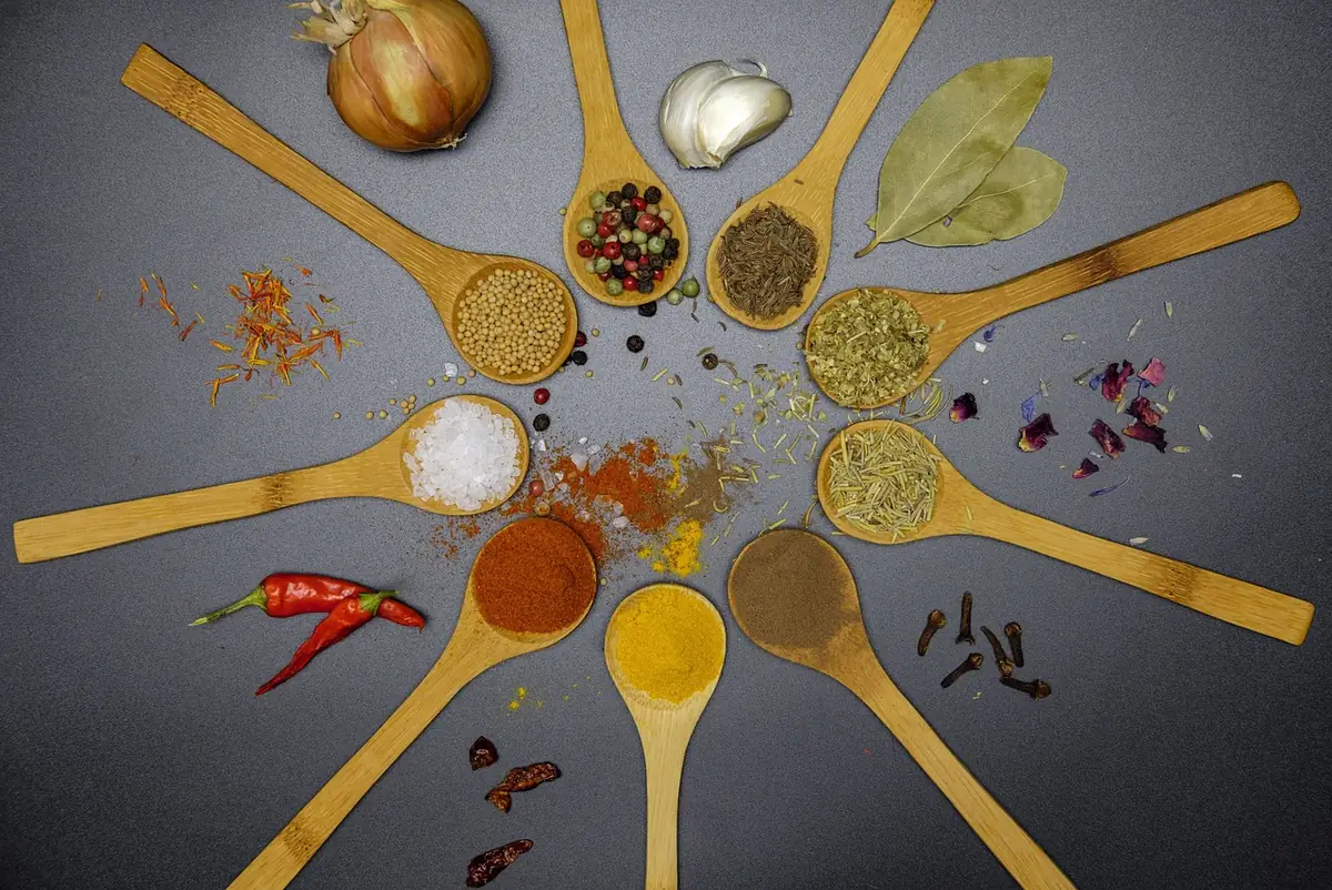 Wooden spoons of paprika, salt, pepper and dried herbs, similar to the spices in this homemade salmon seasoning