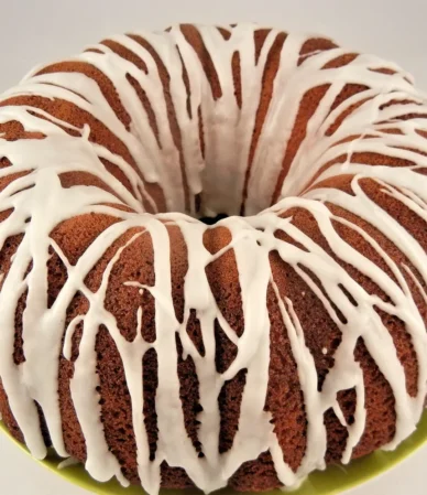 Golden Bundt cake drizzled with white vanilla glaze, similar to a Southern sock it to me cake