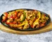 Chopped seared chicken with bell peppers and onion in a cast iron skillet, similar to this chipotle chicken recipe