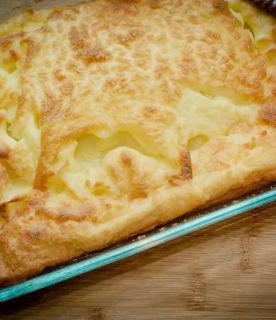 Puffed golden oven pancake with crisp browned edges in a baking dish, similar to this German pancake recipe