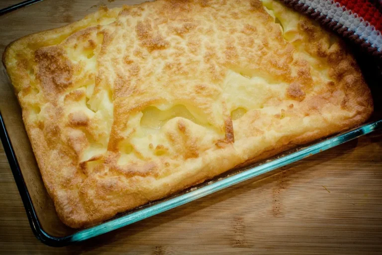Puffed golden oven pancake with crisp browned edges in a baking dish, similar to this German pancake recipe