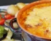 Cheesy potato casserole browned on top in a baking dish, one of the ground beef casserole recipes on this page