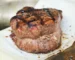 Thick grilled tenderloin steak with a dark peppered crust, similar to the pan-seared filet mignon in this recipe