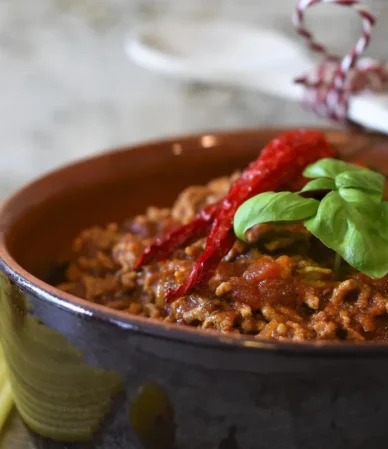Pot of ground beef tomato sauce with macaroni on the side, similar to this homemade beefaroni