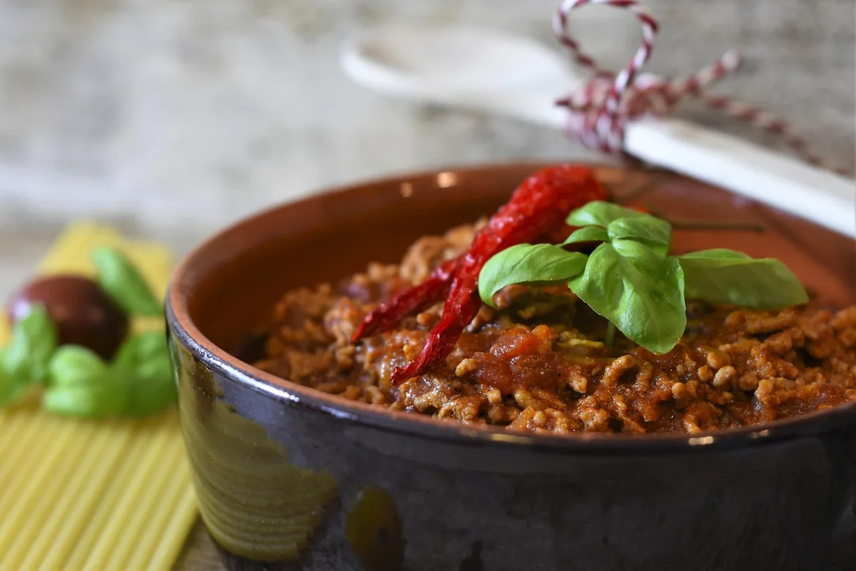 Pot of ground beef tomato sauce with macaroni on the side, similar to this homemade beefaroni