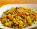 Chicken with rice, peas and carrots in a white bowl, similar to this crockpot chicken and rice