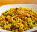 Chicken with rice, peas and carrots in a white bowl, similar to this crockpot chicken and rice