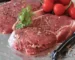 Raw beef steaks seasoned with pepper and herbs on foil, ready for a steak marinade