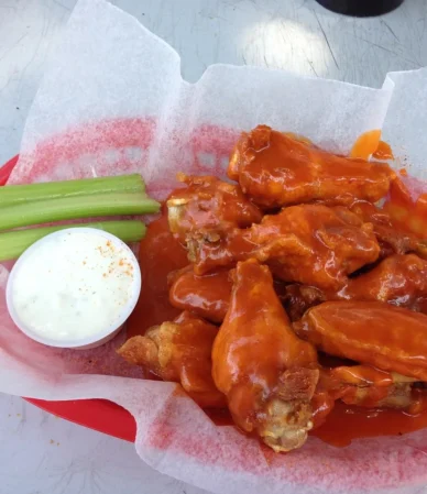 Buffalo wings with celery sticks and ranch, the flavors behind this buffalo chicken dip