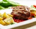 Grilled steak with golden roasted potatoes on a white plate, a steak and potatoes dinner