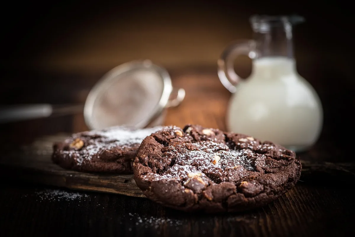 Dark chocolate cookies on a wooden board, crushed for cookies and cream frosting