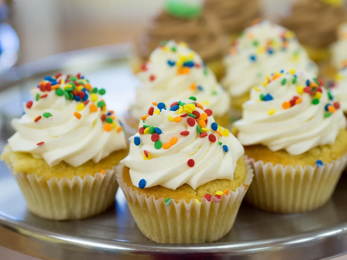 Vanilla cupcakes with swirls of buttercream and rainbow sprinkles