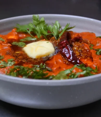 Paneer in a rich tomato butter gravy topped with butter, dried chiles and cilantro, one of these easy paneer recipes